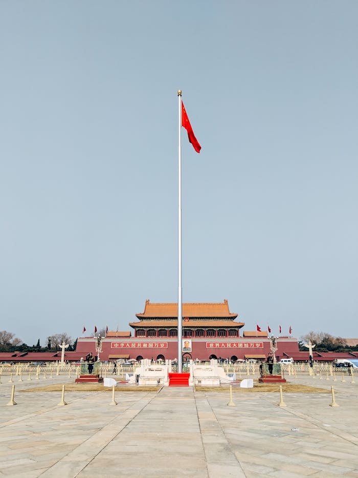 Vertical view of the iconic Tiananmen Square with raised Chinese flag in Beijing, China.