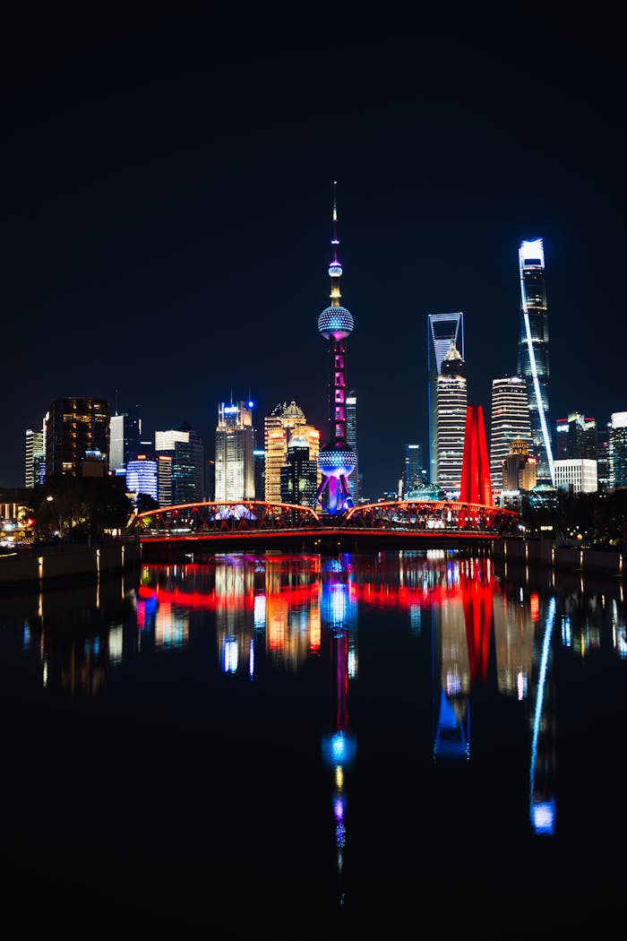 Stunning night view of Shanghai skyline with vibrant reflections in the river.