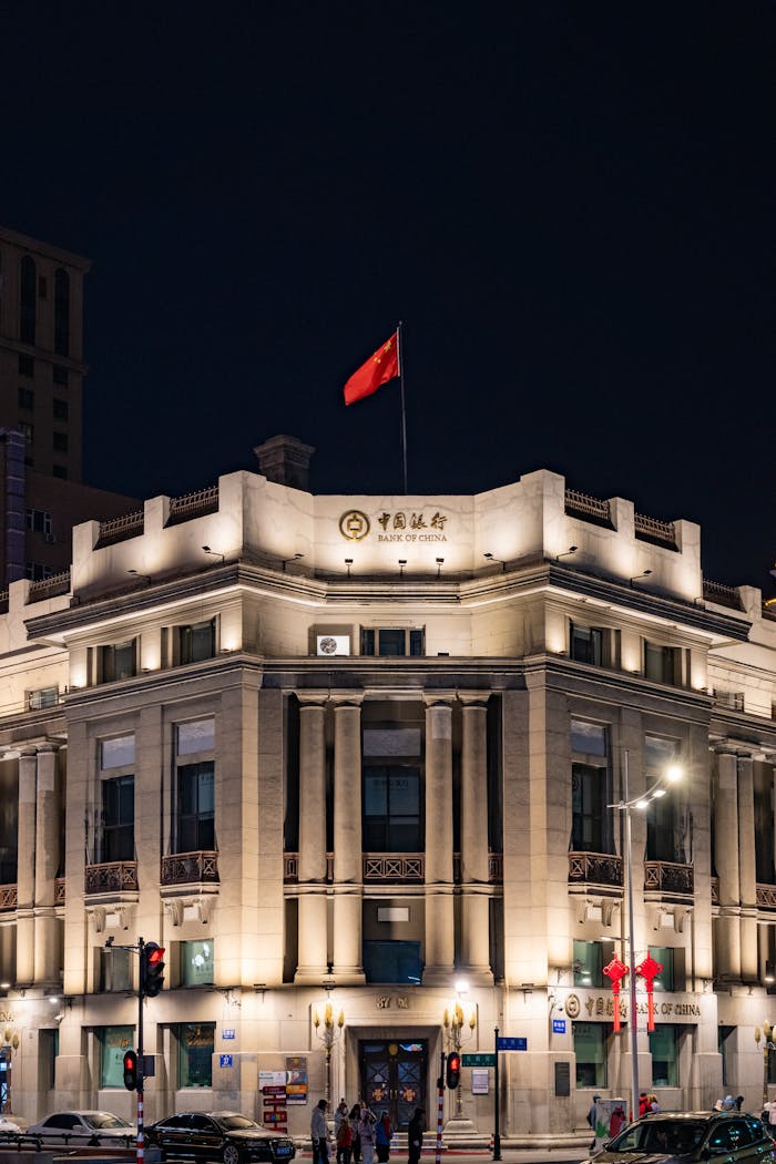 Night view of an illuminated historic building with a flag in Harbin, China.