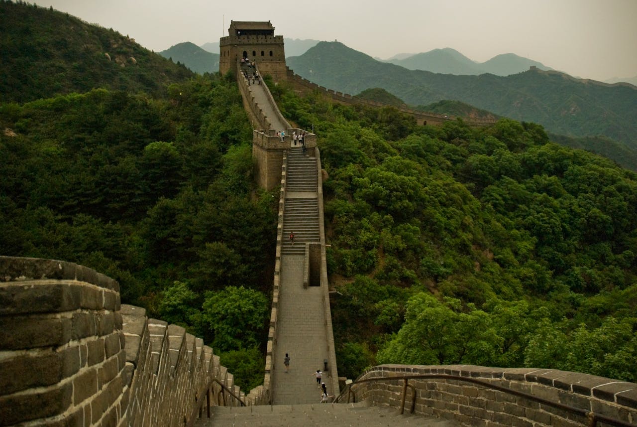 Captivating photo of the Great Wall of China with lush green mountains in Beijing.